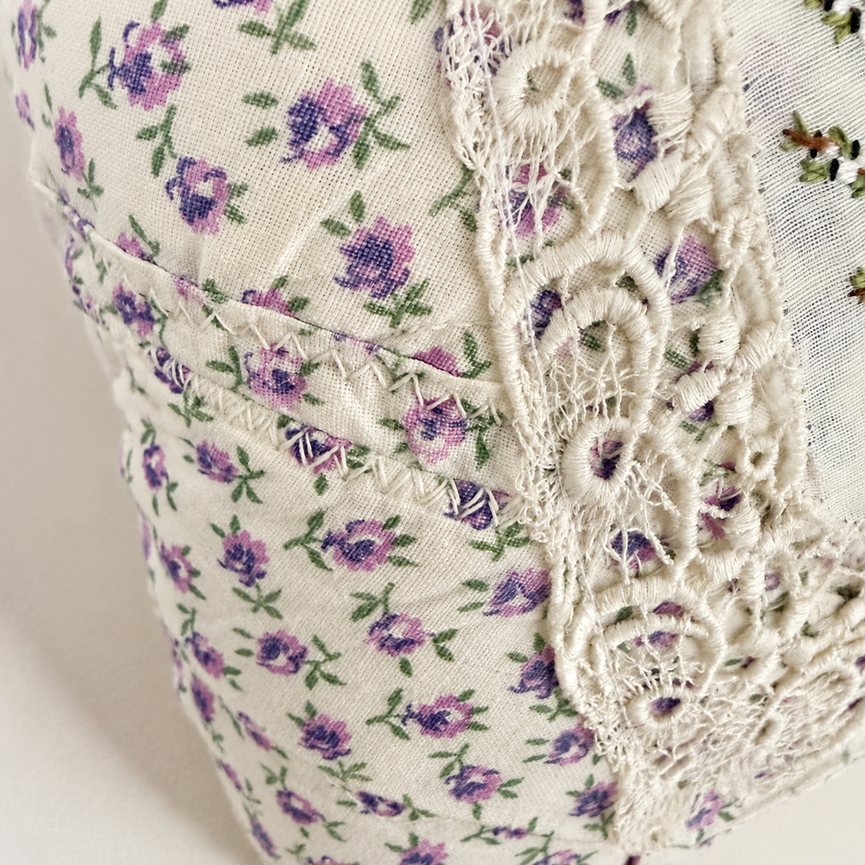 Detail of vintage floral fabric and lace on handmade heart pillow