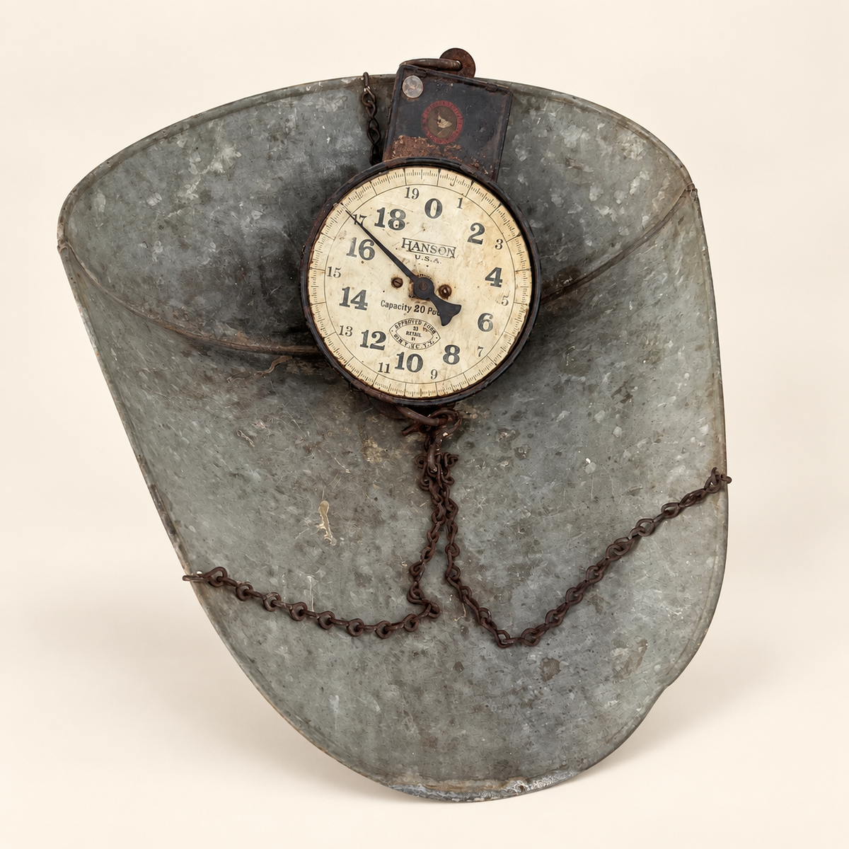 Hanson scoop scale standing upright, dial and draped chains over the galvanized scoop