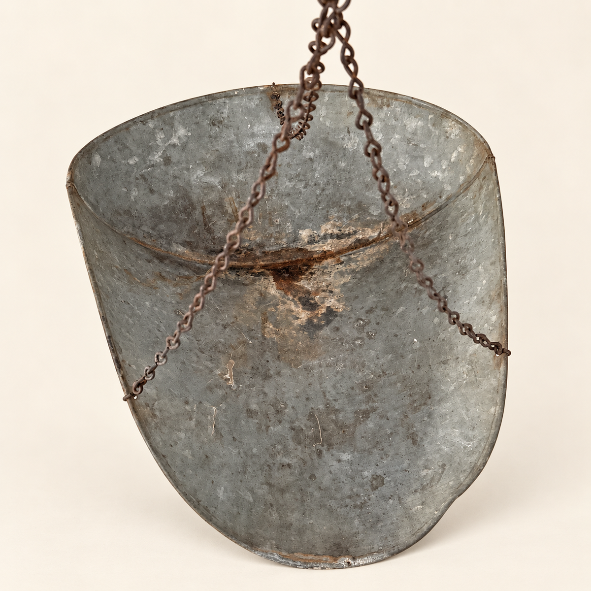 Inside the galvanized scoop with the chains that hang it from the dial