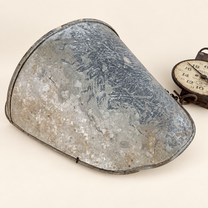 Underside of the galvanized scoop showing the spangled zinc surface