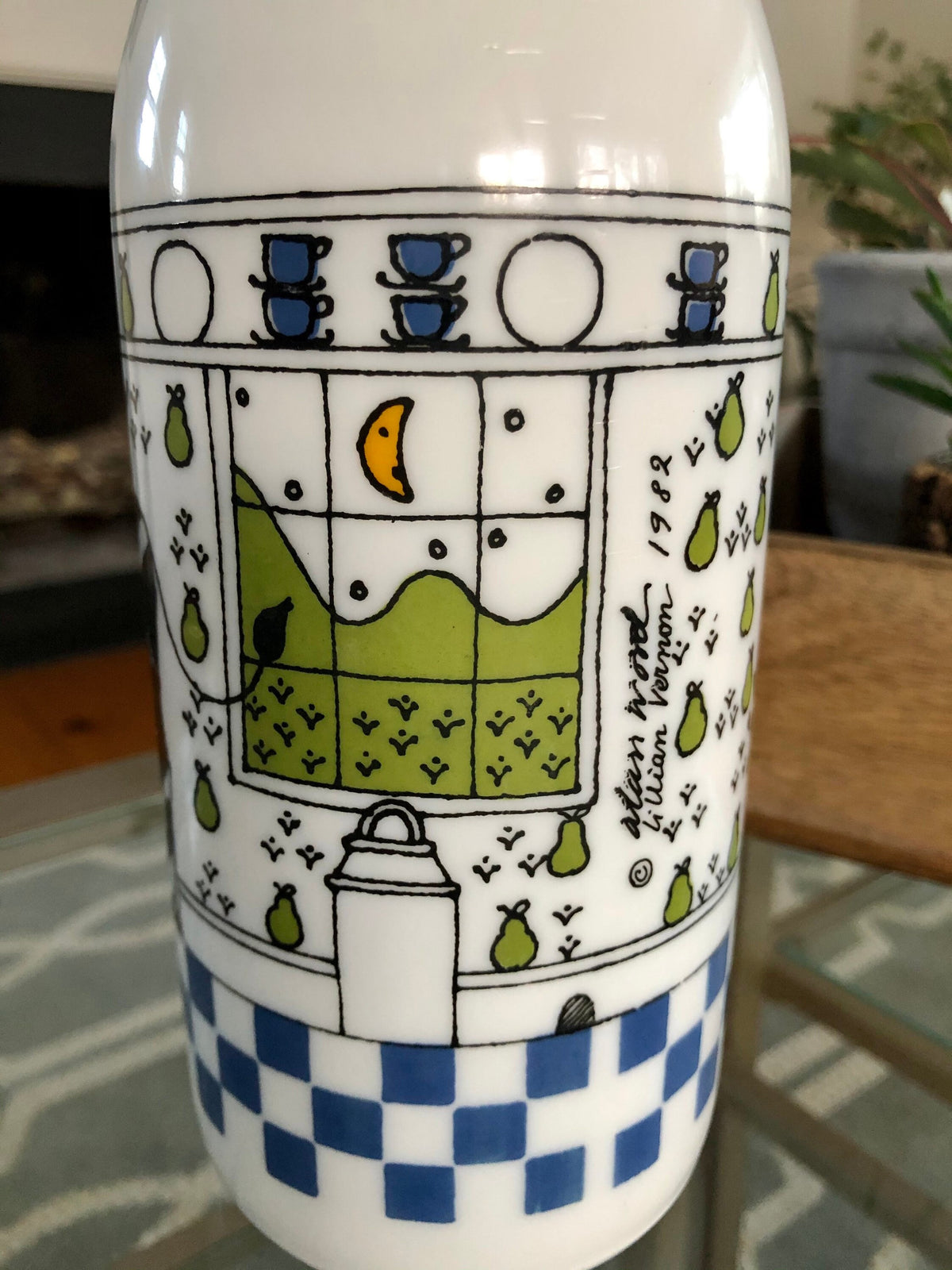 Close-up of the printed country kitchen scene on the Lillian Vernon milk glass bottle