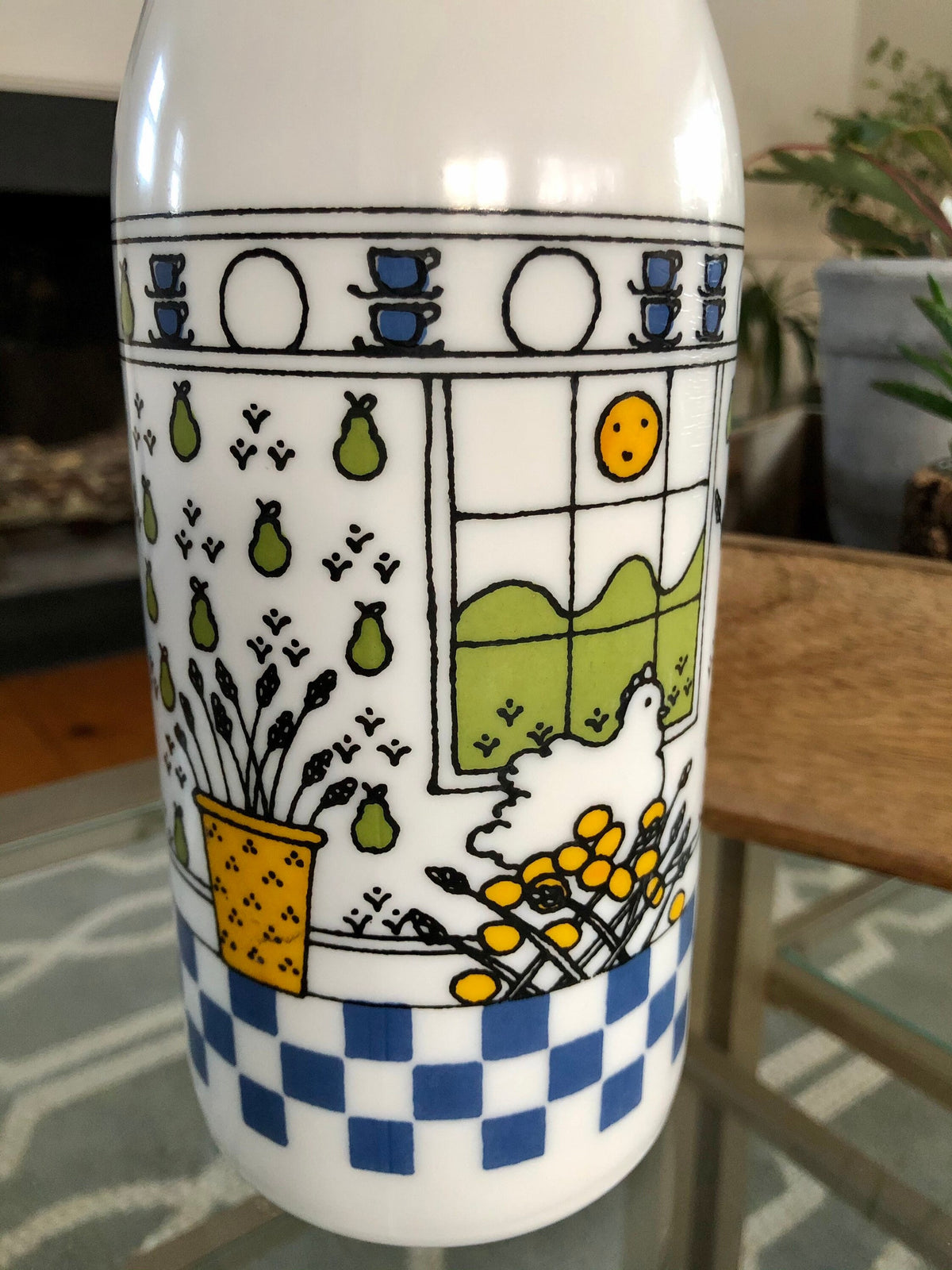 Close-up of the window, green pears, and yellow flower basket on the milk glass bottle