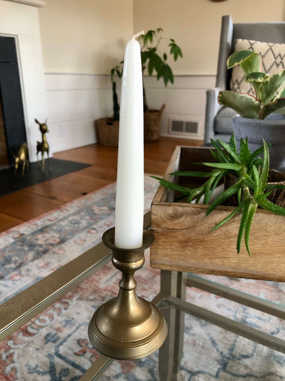 Vintage brass candlestick with a taper candle