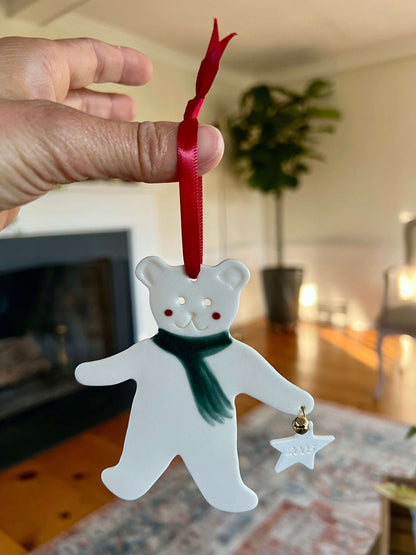 Handmade ceramic Christmas ornament of a bear in a green scarf holding a 2005 star, from Vermont — detail view