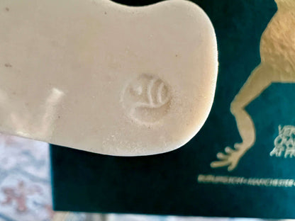 Handmade ceramic Christmas ornament of a bear in a green scarf holding a 2005 star, from Vermont — detail view