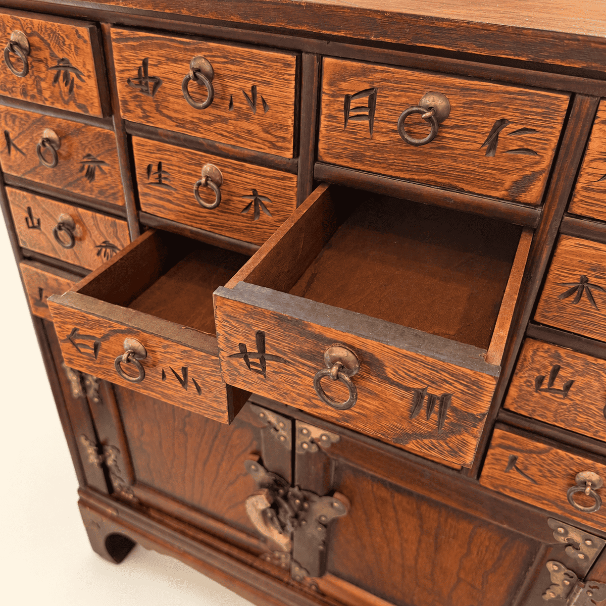 Korean medicine chest with one drawer pulled open, carved characters on drawer fronts