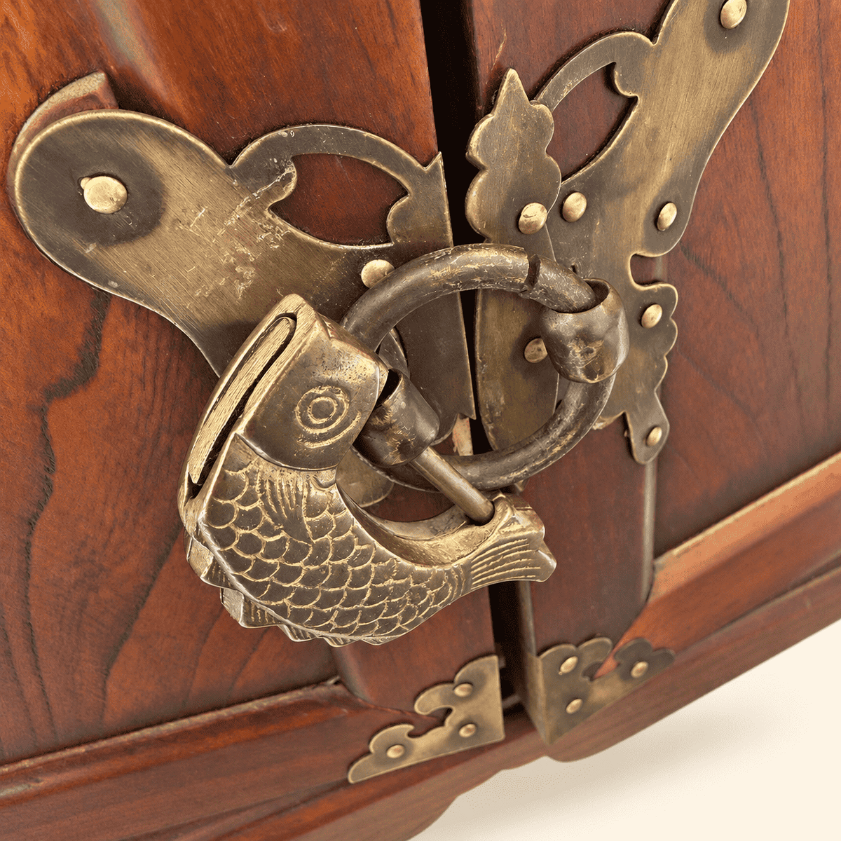 Close-up of brass fish lock and ring pull on Korean medicine chest doors