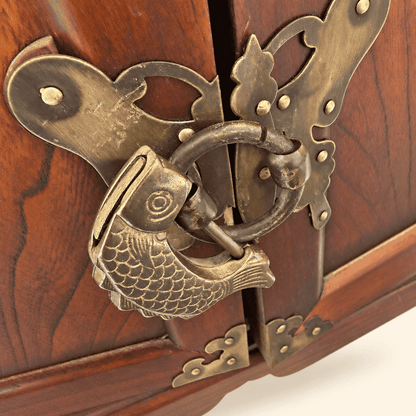 Close-up of brass fish lock and ring pull on Korean medicine chest doors