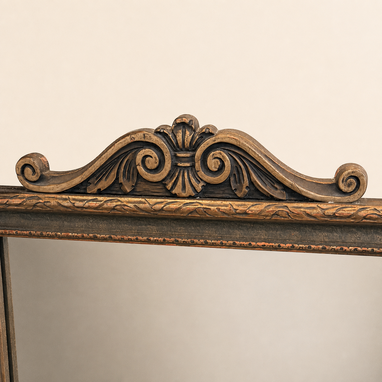 Carved scrolled crest at the top of the antique La France tapestry mirror