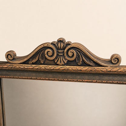 Carved scrolled crest at the top of the antique La France tapestry mirror