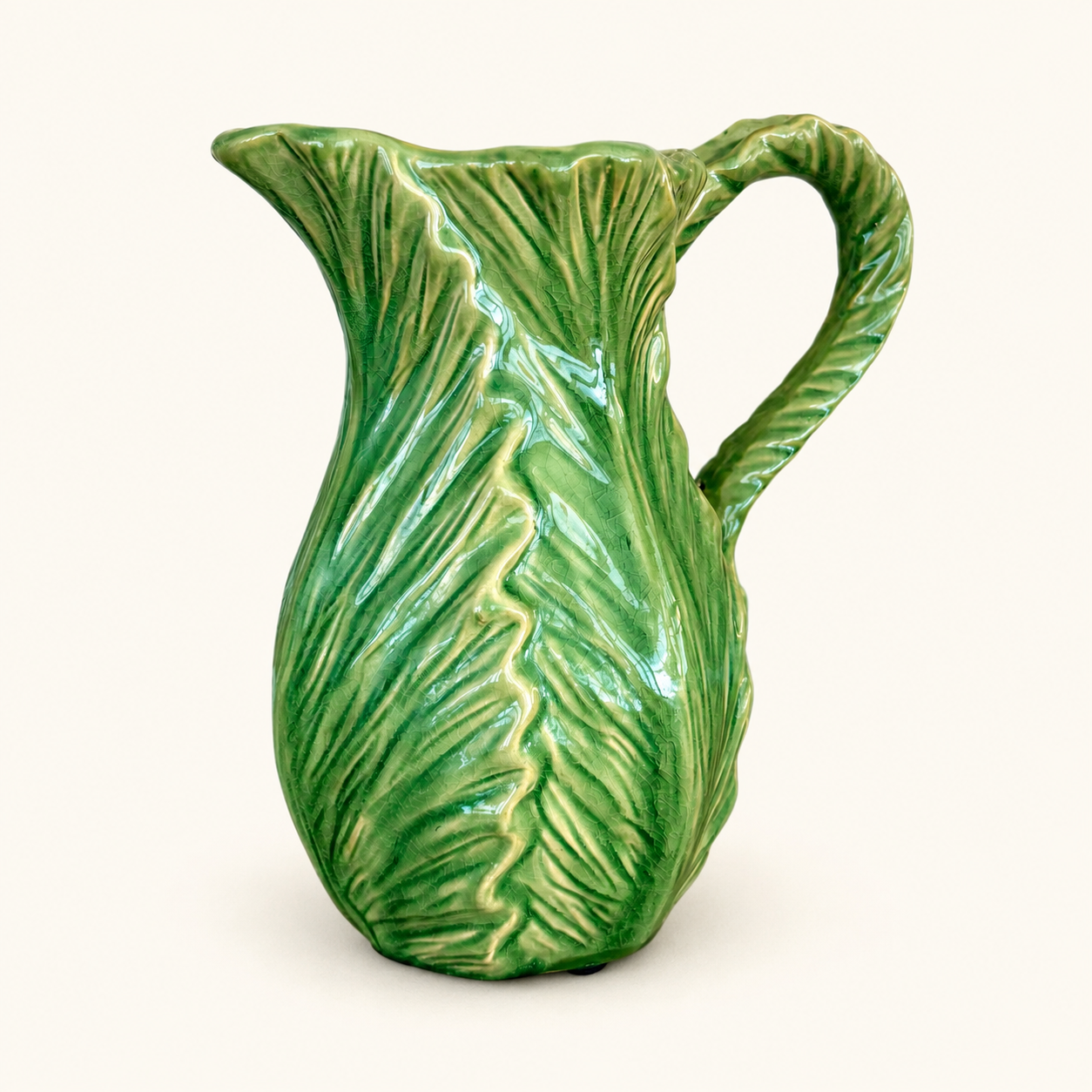 Green majolica cabbage leaf pitcher with twisted vine handle, front view