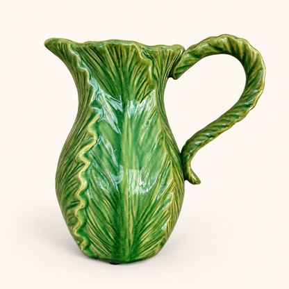 Side view of green cabbage leaf pitcher with leaf-form handle