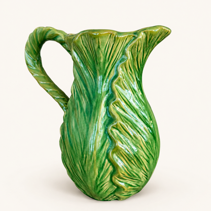 Angled view of green cabbage leaf majolica pitcher showing molded leaves