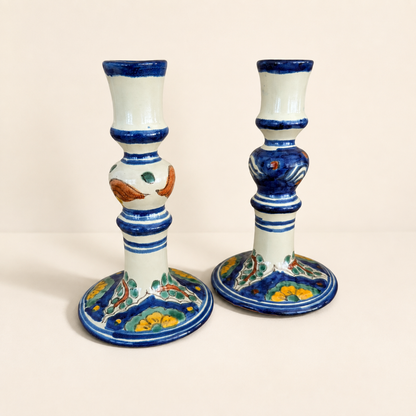 Pair of Mexican Talavera-style candlesticks with cobalt blue bands and floral bases, front view