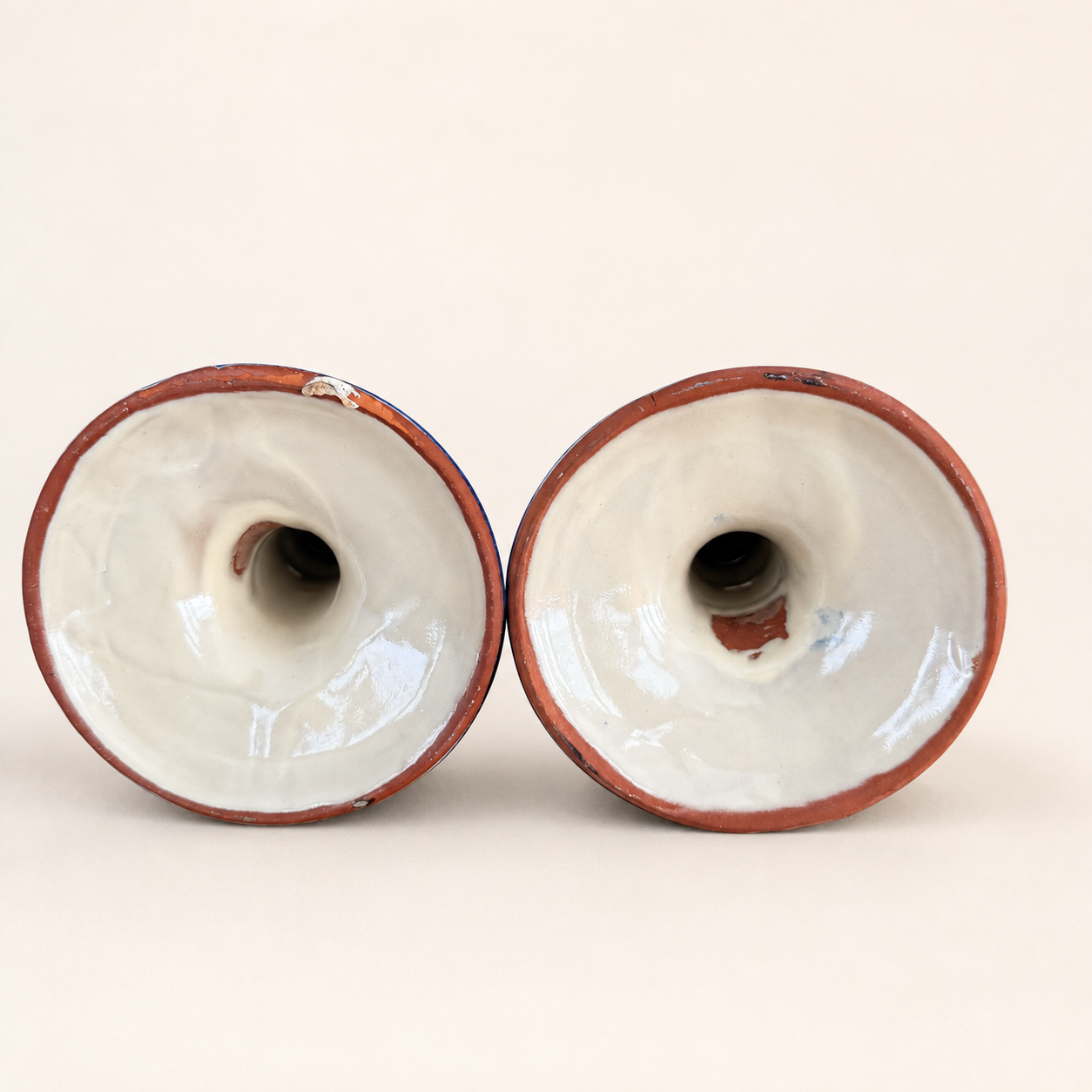 Underside of Talavera candlesticks showing red terracotta clay bases