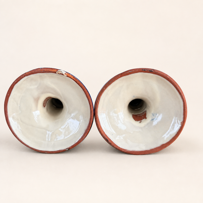 Underside of Talavera candlesticks showing red terracotta clay bases