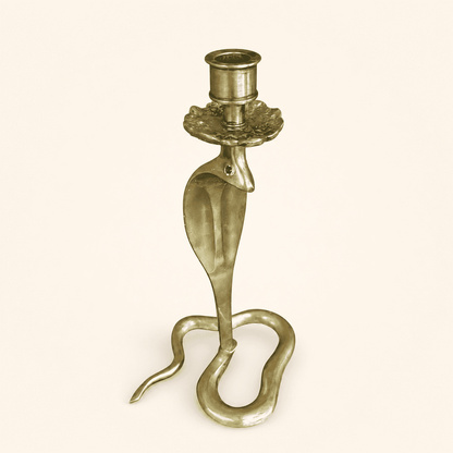 Full front view of handcrafted brass cobra candlestick with green glass eyes