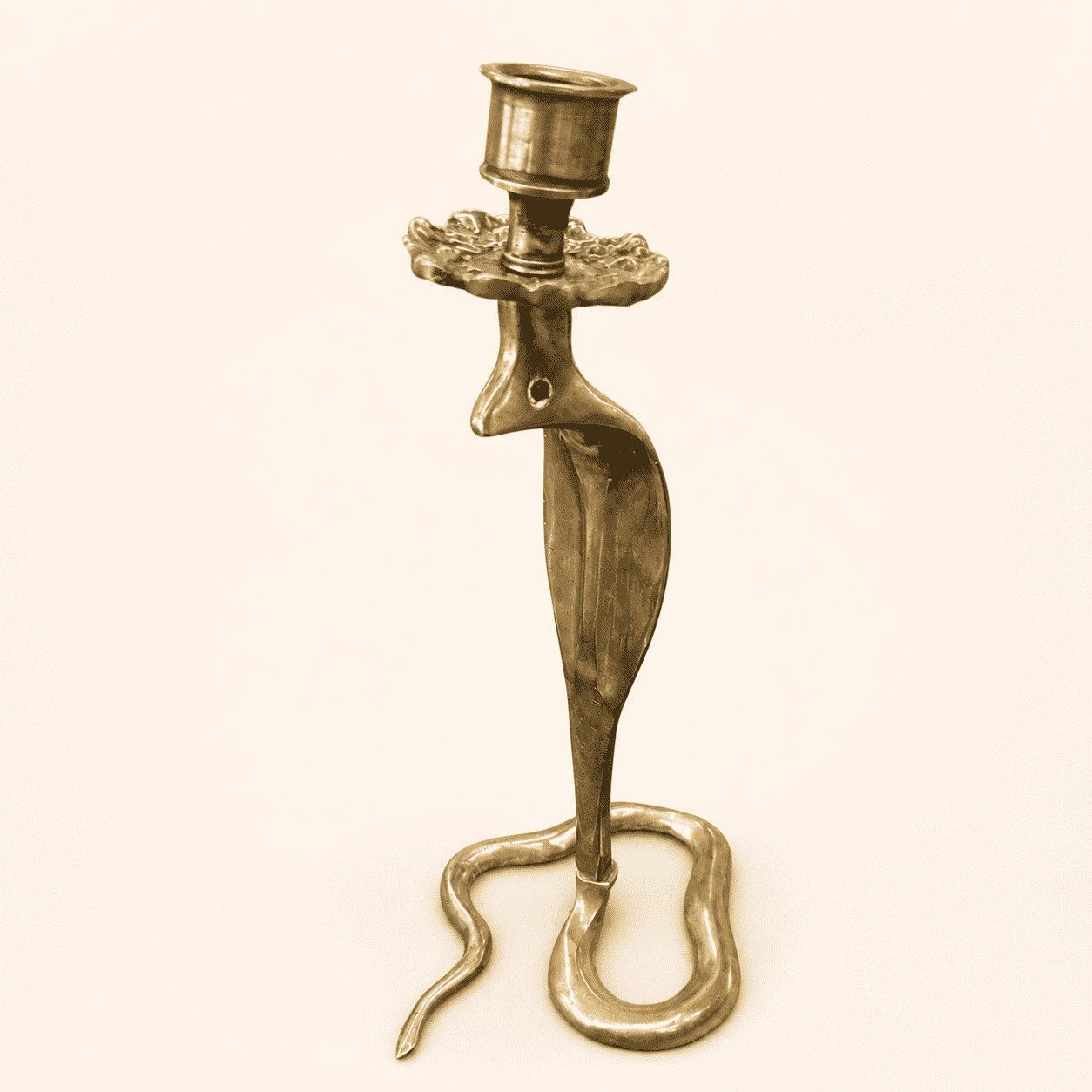 Moroccan brass cobra candlestick with emerald glass eyes and coiled base, front view