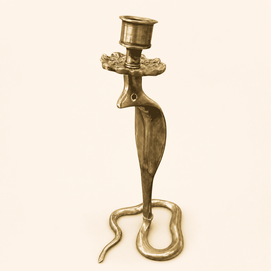 Moroccan brass cobra candlestick with emerald glass eyes and coiled base, front view