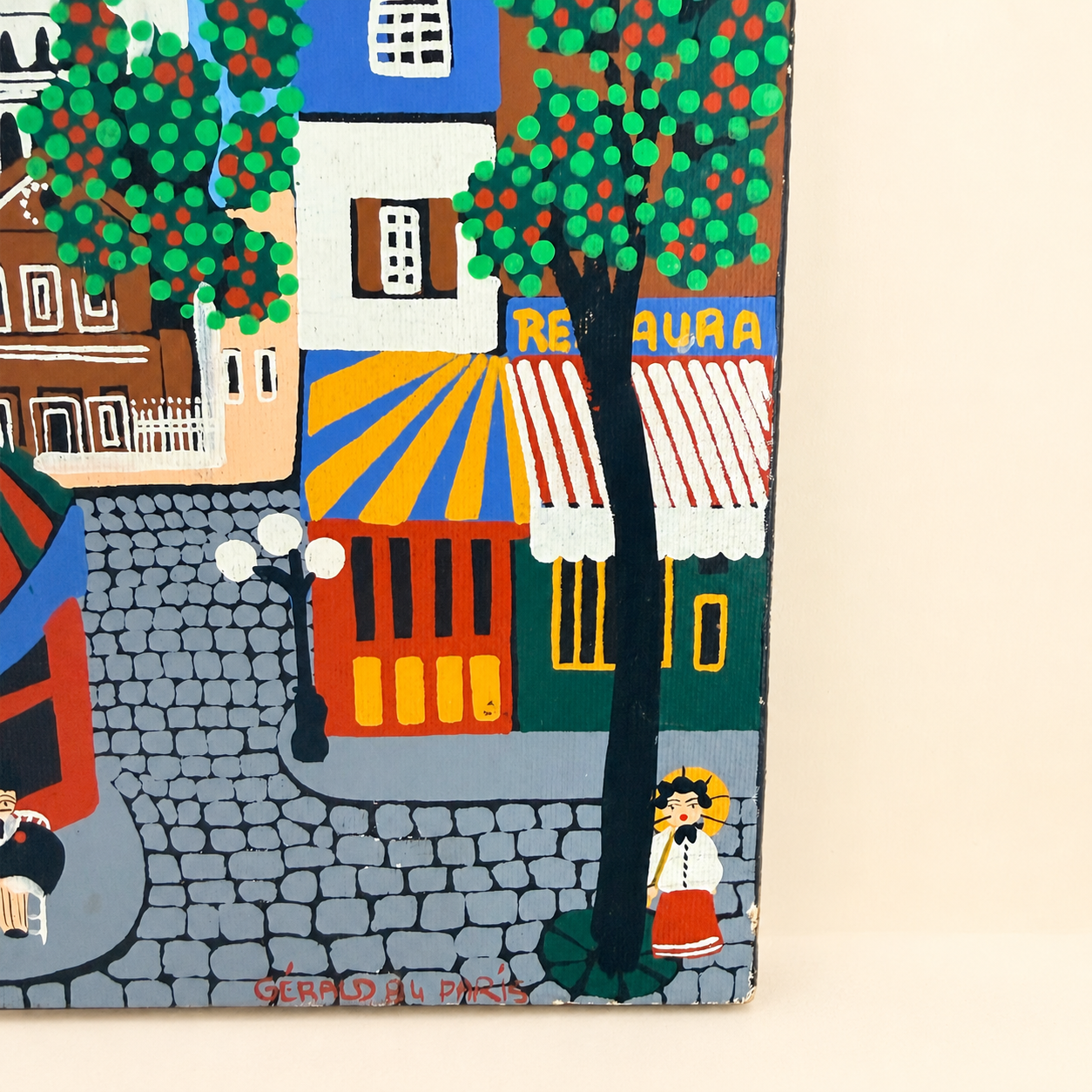 Close-up of red "Gérald 84 Paris" signature on folk art painting