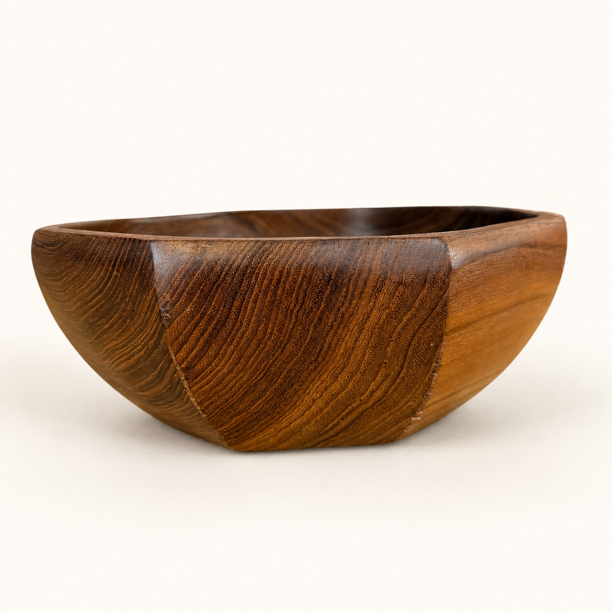 Side view of faceted teak bowl with dramatic grain