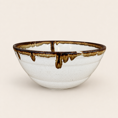 Detail of brown and caramel drip glaze on bowl rim