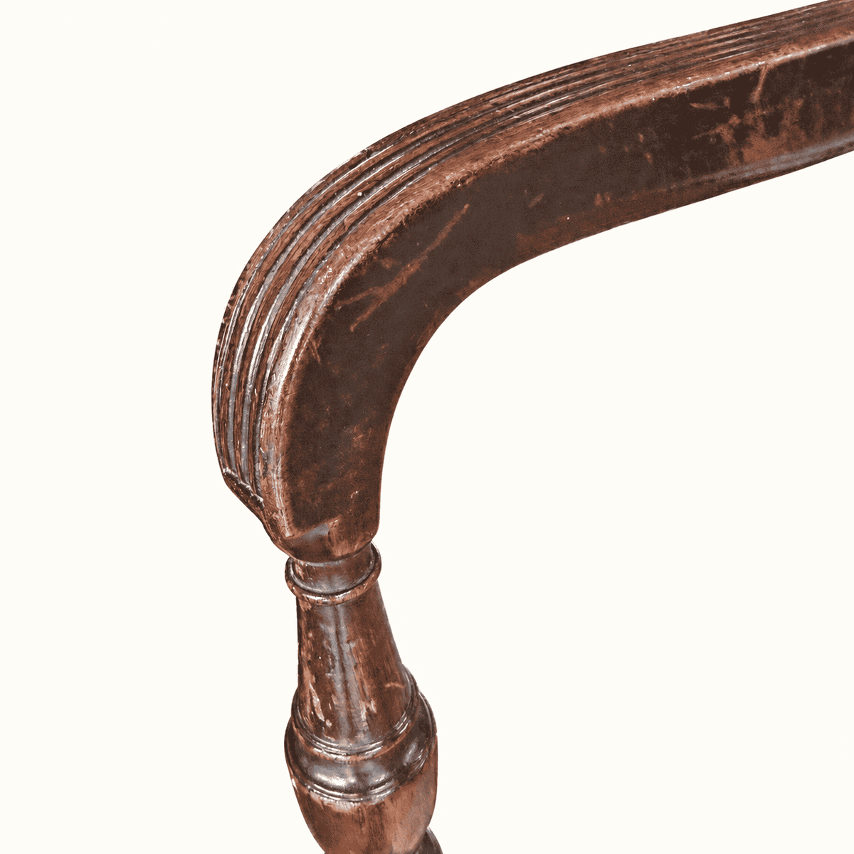 Scrolled reeded arm curving down to its turned support