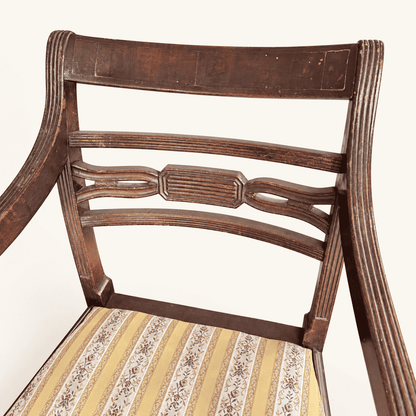 Reeded top rail and carved center splat of the bar back, worn finish
