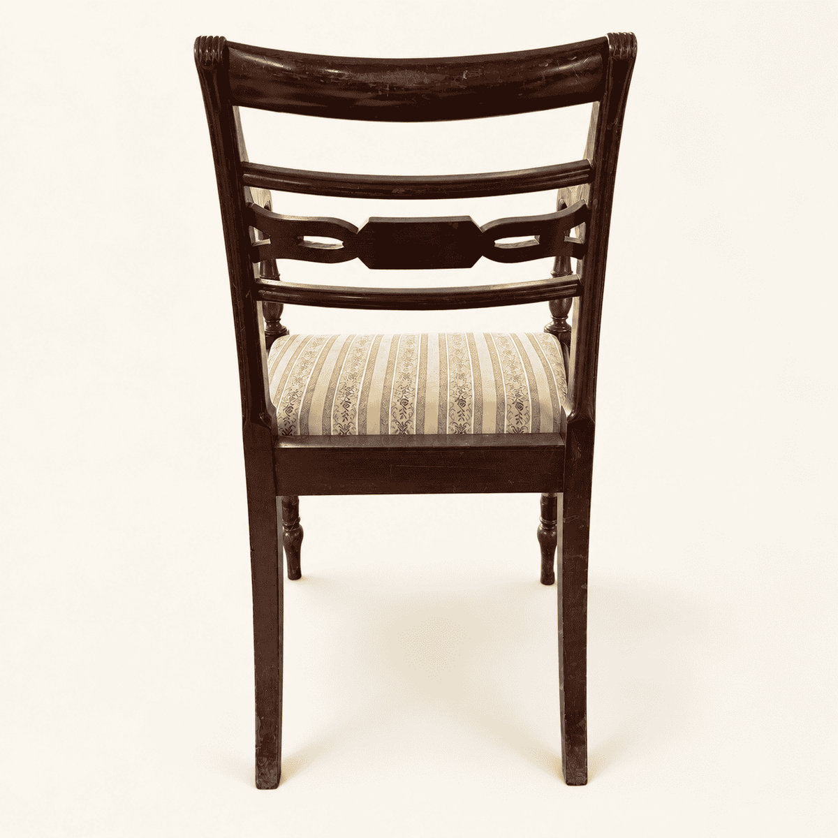 Back of the chair with the carved splat and sabre back legs