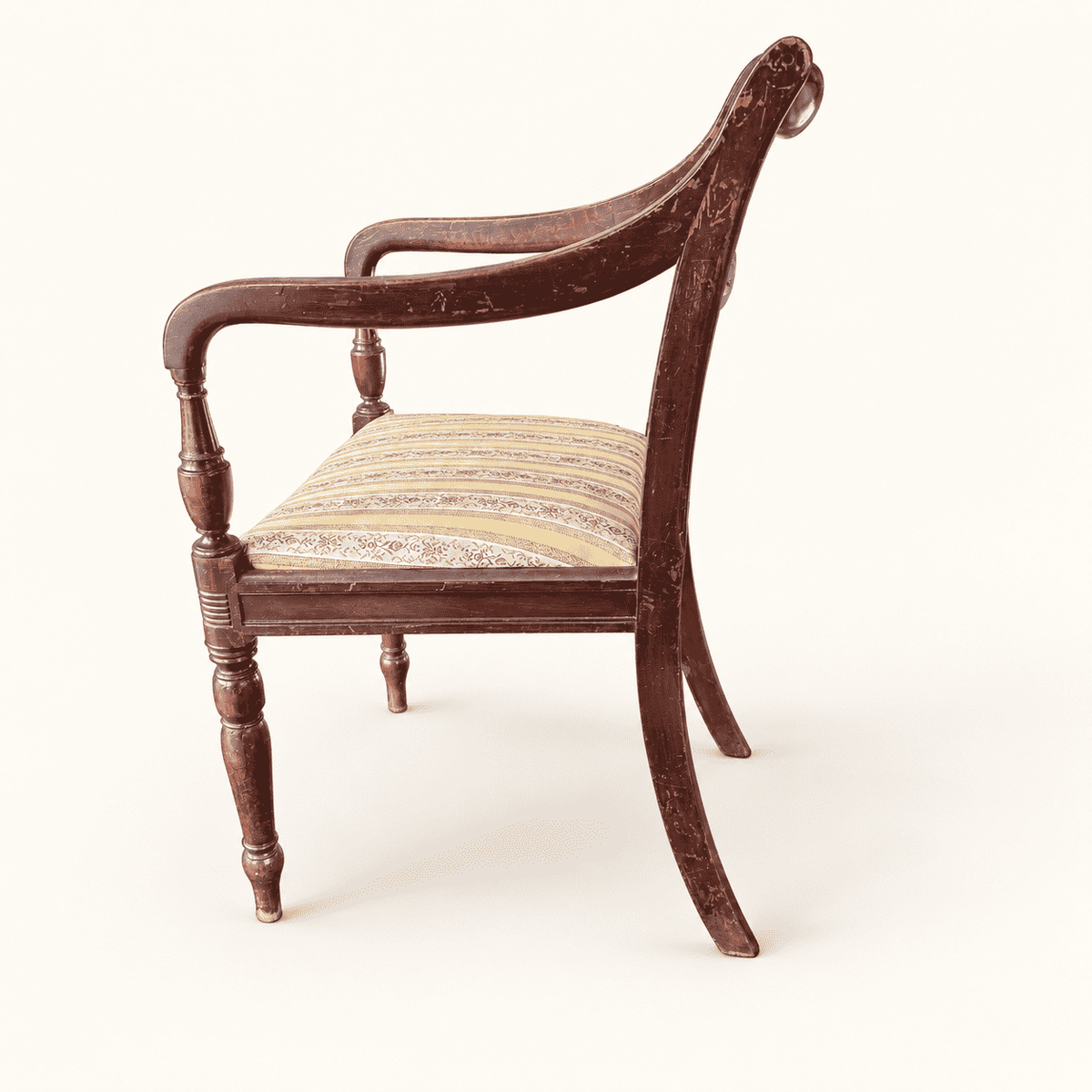 Side profile showing the scrolled arm and splayed sabre back leg