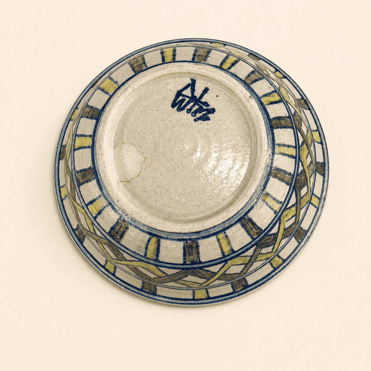 Base of studio pottery bowl showing blue painted artist's signature