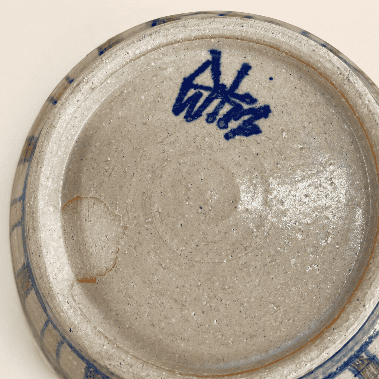 Base of studio pottery bowl showing blue painted artist's signature
