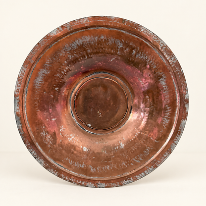 Tinned copper charger straight on, concentric hammered rings around the raised center