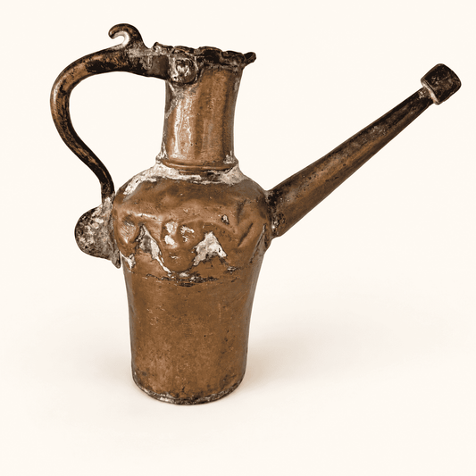 Antique hand-forged tinned copper ewer, front view with a long straight spout and high arched handle