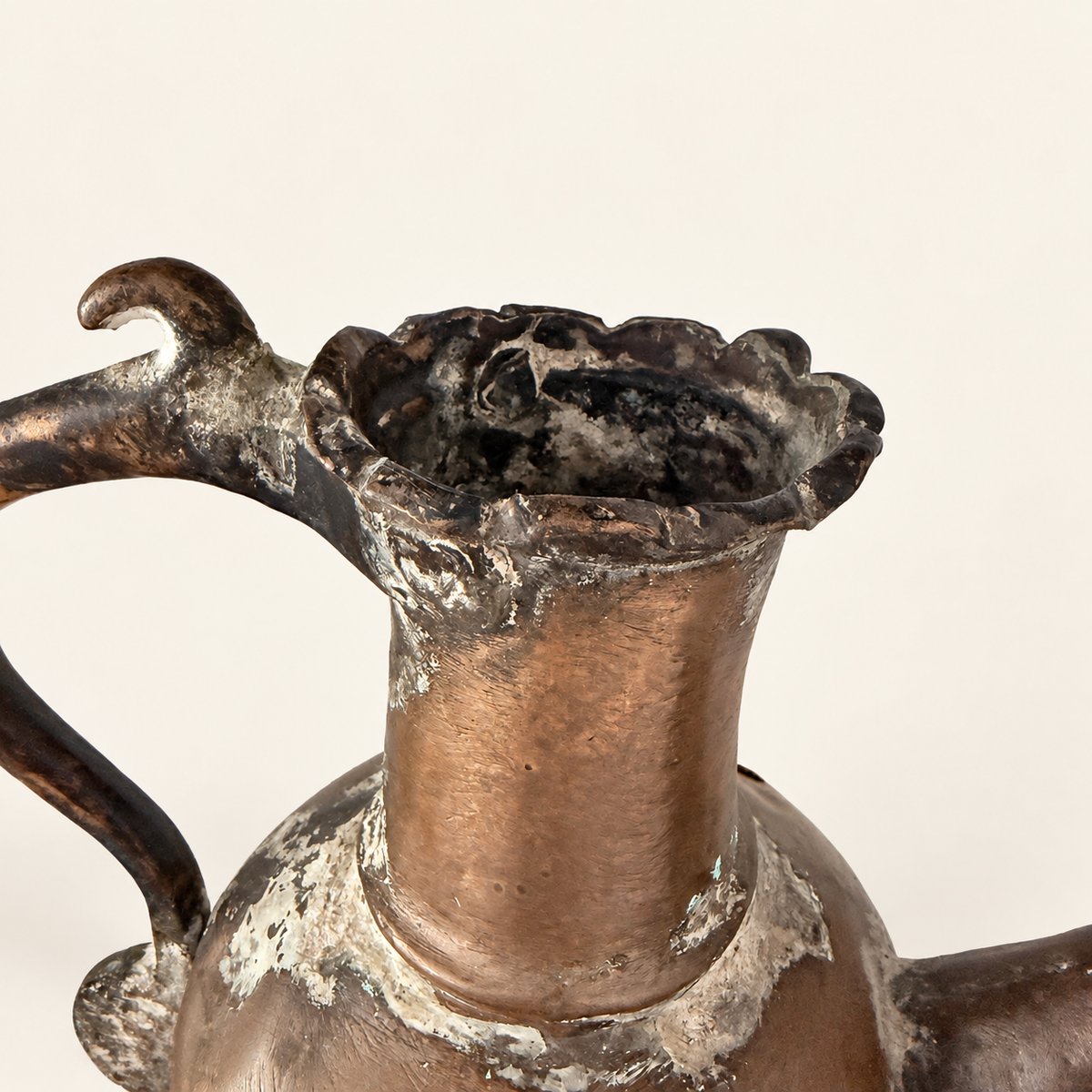 Crimped rim and tin-lined mouth of the ewer seen from above