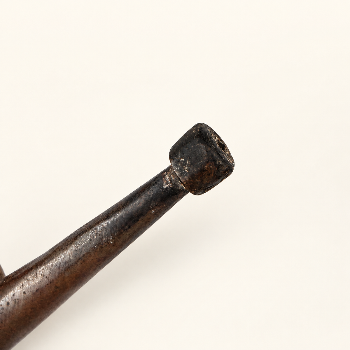 Capped end of the long pouring spout, close detail