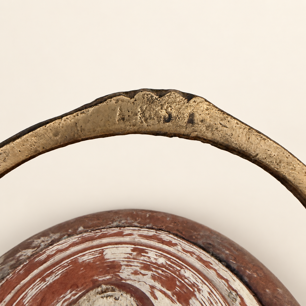 Stamped markings on the brass bail handle, close detail