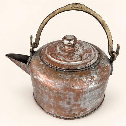 Copper kettle with the brass swing bail raised upright over the lid, spout to the left
