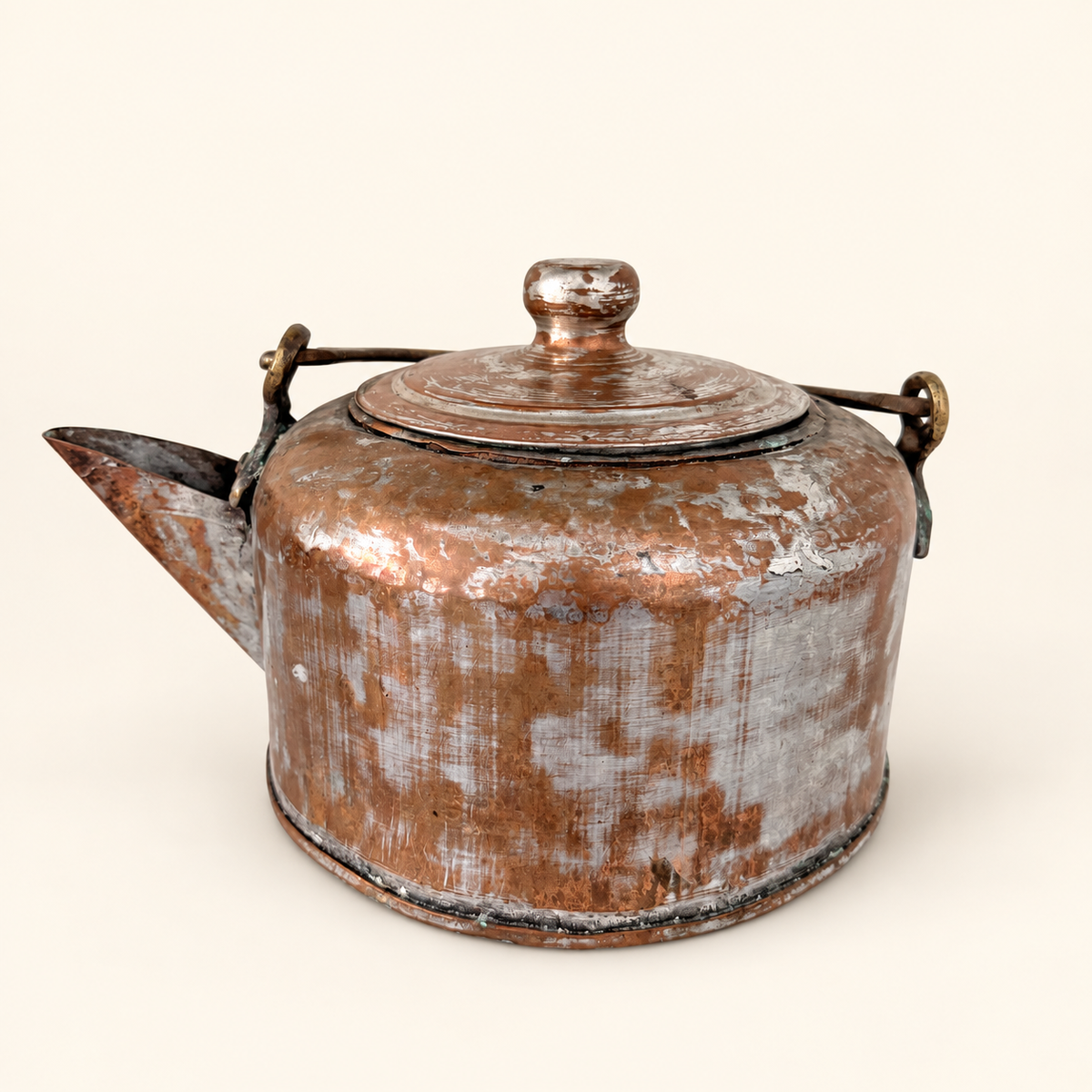 Antique hand-forged tinned copper kettle with a domed lid and brass swing bail, front view with short spout