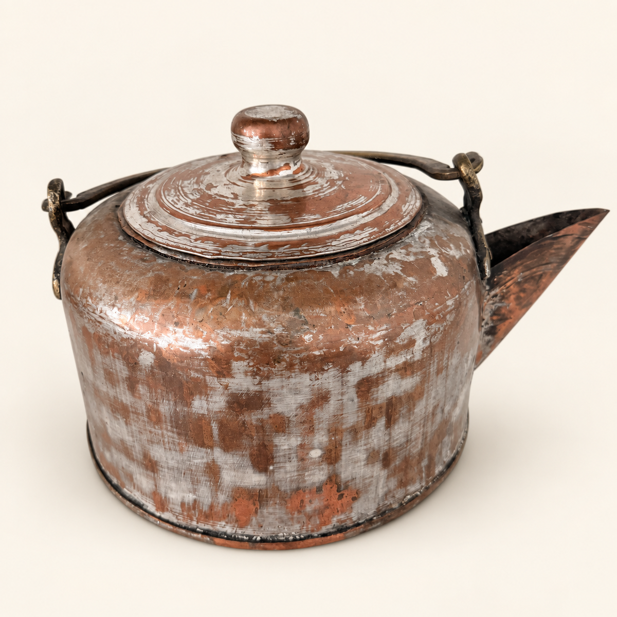 The tinned copper kettle from the other side, spout to the right and bail lowered