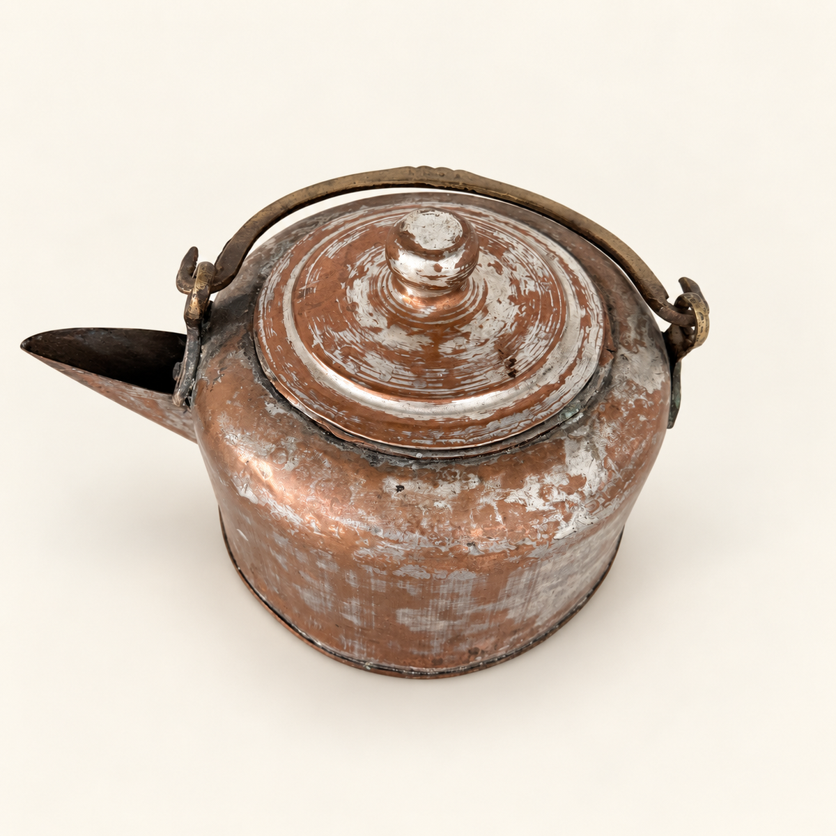 Three-quarter view of the tinned copper kettle showing the domed lid, spout, and brass bail handle