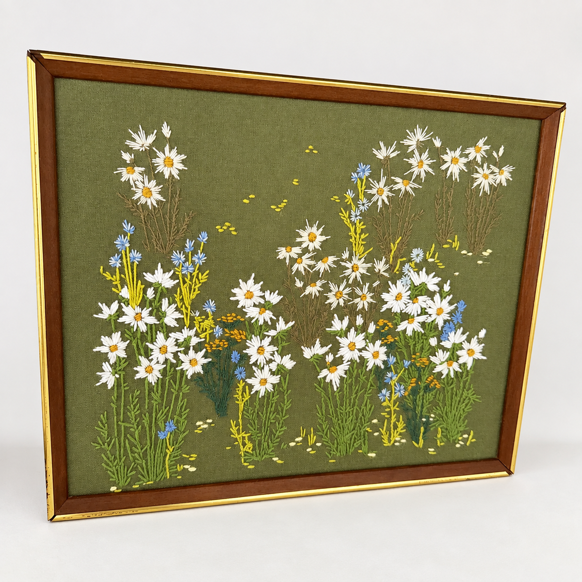 Angled view of framed crewel wildflower meadow in wood and gold frame, photo 2 of 5