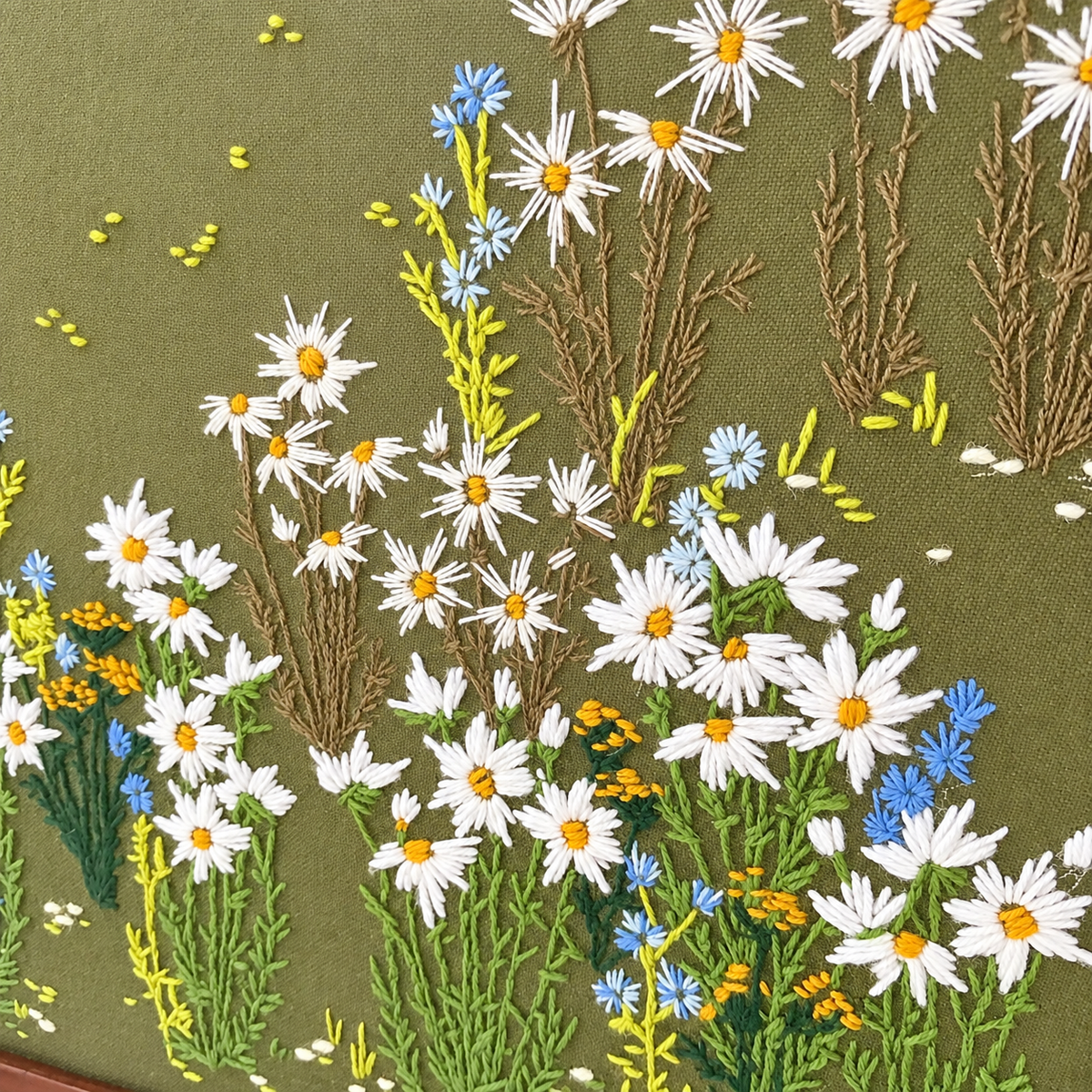 Close-up of stitched white daisies, blue cornflowers and taupe grasses, photo 3 of 5