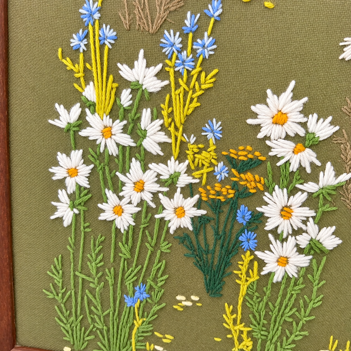 Detail of daisies with yellow centers, cornflowers and mustard tansy in wool crewel, photo 4 of 5