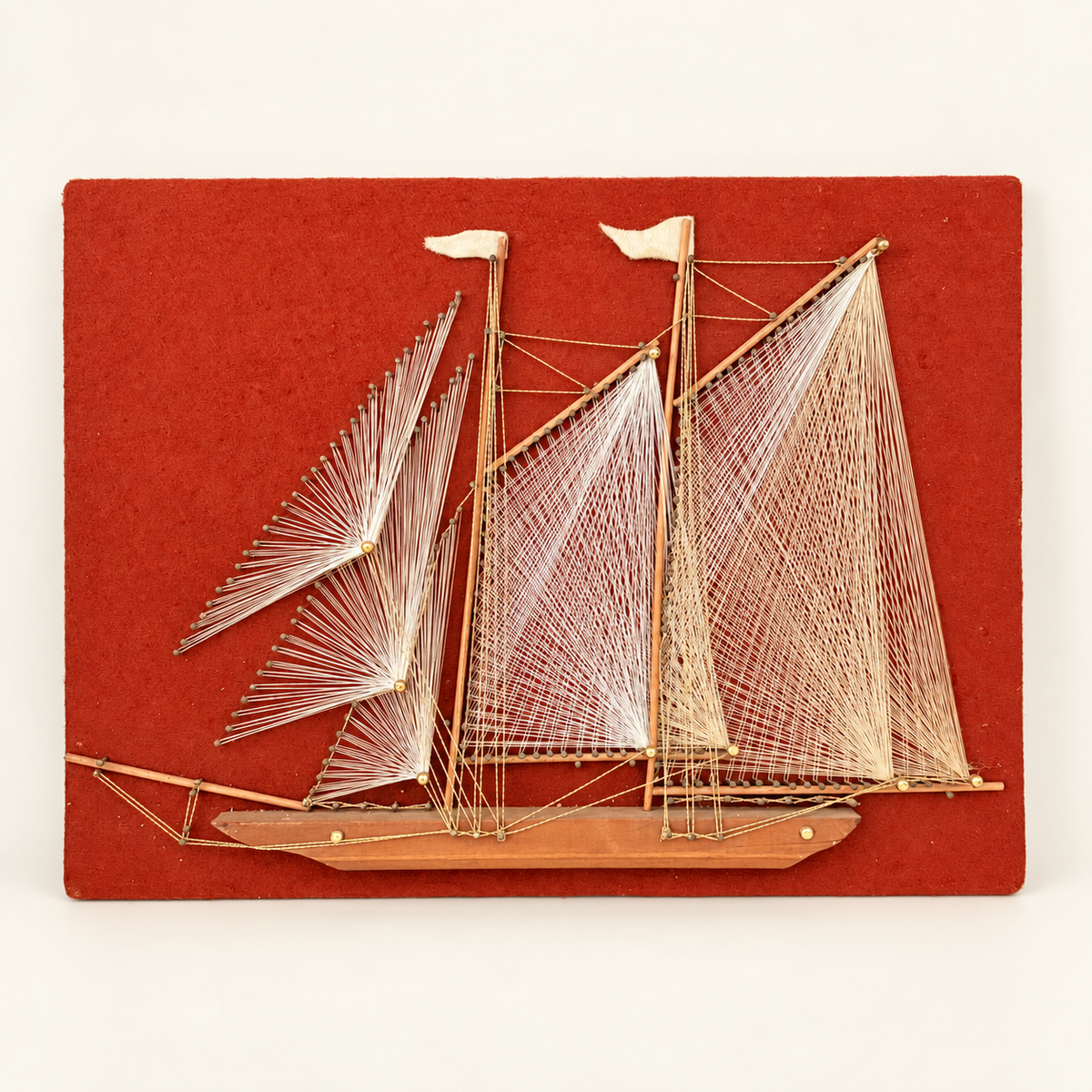 Vintage 1970s string art schooner sailboat on red felt board, front view, photo 1 of 5