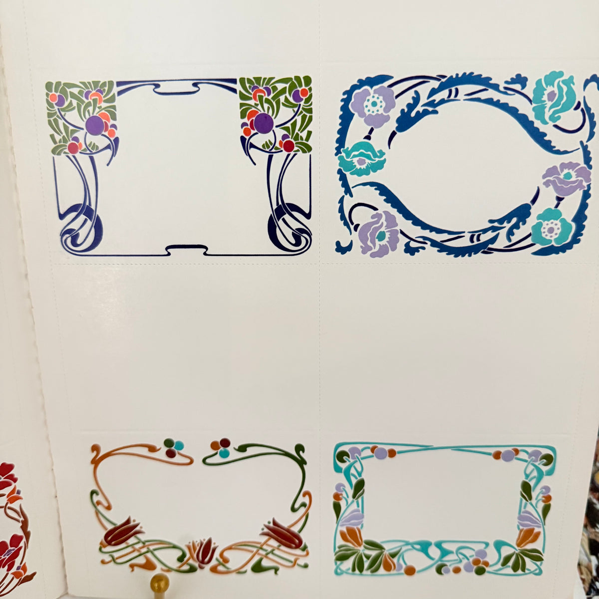 Close-up of colorful Art Nouveau place card designs with vines and flowers, photo 3 of 3