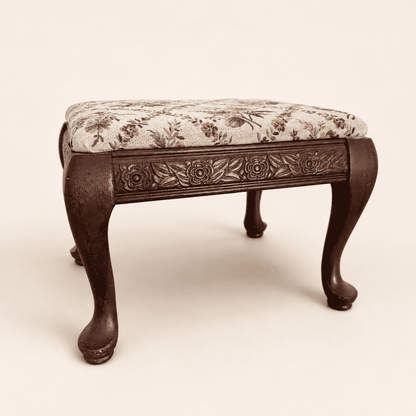Vintage carved footstool with cabriole legs and floral tapestry top, front view