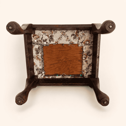 Underside of the footstool showing frame and tapestry-covered base