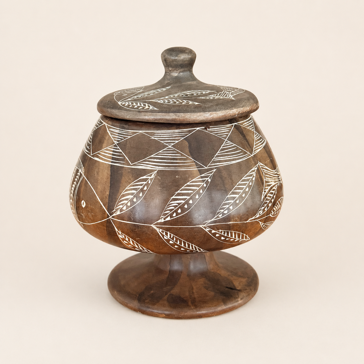 Vintage carved soapstone lidded jar with etched fish and leaf design, front view