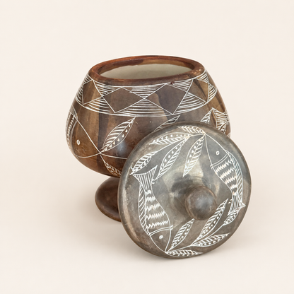 Carved soapstone jar with lid removed showing etched decoration